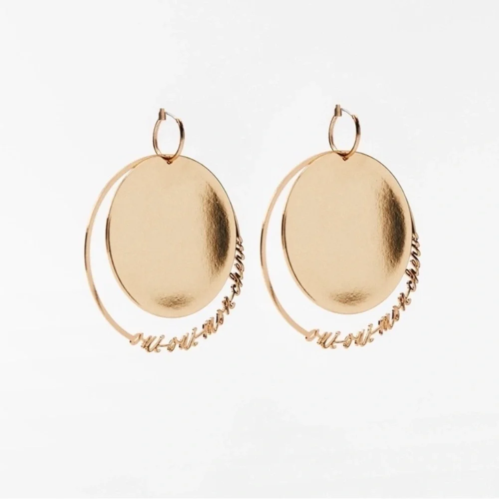 - NWT. Zara Golden Round Flat Metal Earrings with Text Detail.